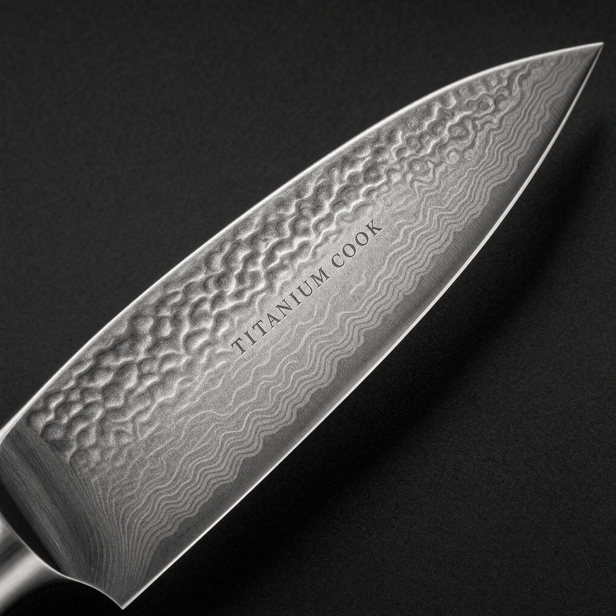 Detail of the hammered blade engraved TITANIUM COOK — Nocturne office